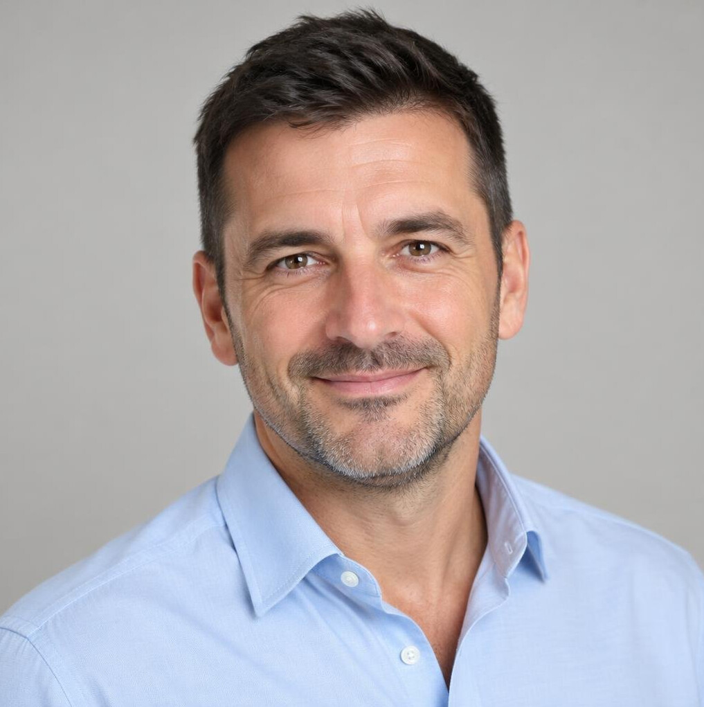 Portrait of a man with short dark hair in a light shirt