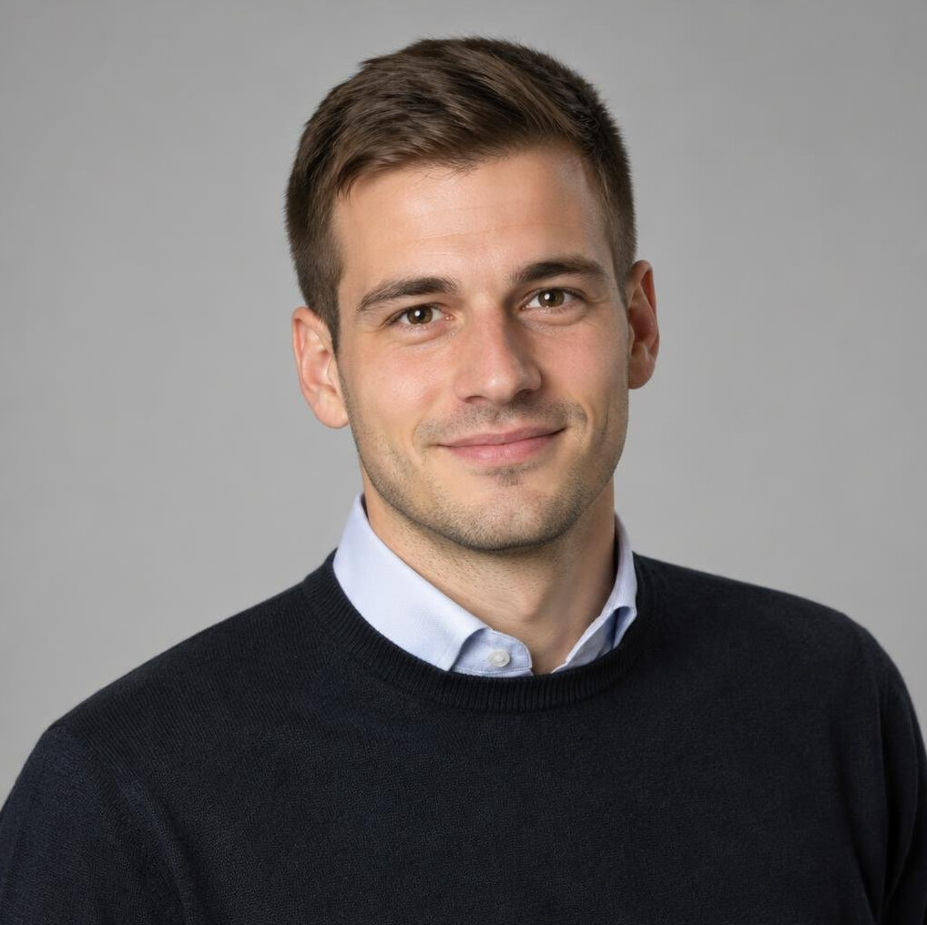 Portrait of a young man with short brown hair in a dark sweater